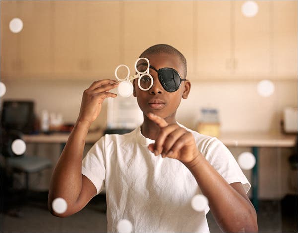 young boy playing with eye equipment