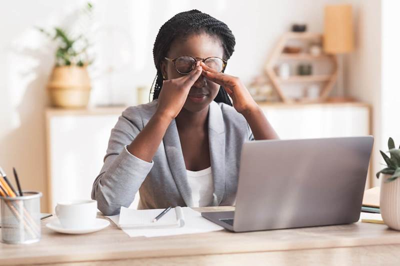 woman with eye strain with glasses at eye clinic in Abuja